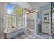 Charming bathroom featuring a clawfoot tub, patterned tile, and natural light at 217 S Ellis St, Salisbury, NC 28144