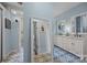 Bathroom features double sink vanity, vintage decor, and patterned tile floors at 217 S Ellis St, Salisbury, NC 28144
