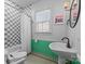 Bathroom features checkered tile, a pedestal sink, and modern toilet with bidet at 217 S Ellis St, Salisbury, NC 28144