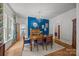 Charming dining room featuring a fireplace, chandelier, and access to other rooms at 217 S Ellis St, Salisbury, NC 28144