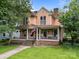 Beautiful two-story house with a charming front porch and well-maintained lawn at 217 S Ellis St, Salisbury, NC 28144