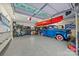 Organized garage with epoxy flooring, overhead storage, and a vintage blue truck at 217 S Ellis St, Salisbury, NC 28144
