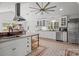 Spacious kitchen with white cabinets, stainless steel appliances, and unique tiled floors at 217 S Ellis St, Salisbury, NC 28144