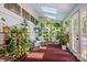 Sunroom featuring skylights, brick floors, seating area, and plant decor at 217 S Ellis St, Salisbury, NC 28144