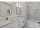 This primary bathroom offers dual sinks, gold fixtures, and a shower-tub combination with marble walls at 2220 Mooresville Rd, Salisbury, NC 28147