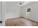 This bedroom offers wood flooring, a ceiling fan, and a large window to let the sunshine in at 2220 Mooresville Rd, Salisbury, NC 28147