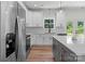 Modern kitchen with quartz countertops, stainless steel appliances, hardwood floors and gray kitchen island at 2220 Mooresville Rd, Salisbury, NC 28147