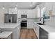 Kitchen with stainless steel appliances, black hardware and fixtures, hardwood floors and quartz countertops at 2220 Mooresville Rd, Salisbury, NC 28147