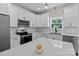 Bright kitchen with white cabinets, quartz countertops, stainless steel appliances, and hardwood floors at 2220 Mooresville Rd, Salisbury, NC 28147