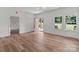 Bright living room features wood flooring, multiple windows, and an open door to the backyard at 2220 Mooresville Rd, Salisbury, NC 28147