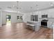 Open-concept kitchen and living space with island seating, stainless steel appliances and modern lighting at 2220 Mooresville Rd, Salisbury, NC 28147