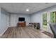 Finished basement with wood-look floors, a TV, and access to the outdoors through double doors at 223 Tennessee Trl, Lincolnton, NC 28092