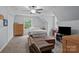 Comfortable bedroom features a ceiling fan, a window view, and additional seating with a brown leather couch at 223 Tennessee Trl, Lincolnton, NC 28092