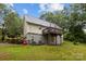 View of the house's exterior showing the side access stairs to the deck, AC unit, and concrete foundation at 223 Tennessee Trl, Lincolnton, NC 28092