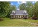 Charming two-story home with a well-manicured front yard, covered porch, and lovely dormers at 223 Tennessee Trl, Lincolnton, NC 28092