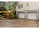 Spacious two-car garage is conveniently attached to the home with stained wooden stairs to side entry at 223 Tennessee Trl, Lincolnton, NC 28092