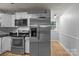 This kitchen features stainless steel appliances, white cabinets, and sleek black countertops at 223 Tennessee Trl, Lincolnton, NC 28092