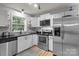 Modern kitchen featuring stainless steel appliances, white cabinets, and ample counter space at 223 Tennessee Trl, Lincolnton, NC 28092