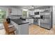 Bright kitchen with stainless steel appliances, white cabinets, and hardwood floors at 223 Tennessee Trl, Lincolnton, NC 28092