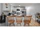 Well-lit kitchen featuring white cabinets, stainless steel appliances and bar seating at 223 Tennessee Trl, Lincolnton, NC 28092
