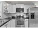The kitchen features white cabinets, stainless steel appliances, and black counter tops at 223 Tennessee Trl, Lincolnton, NC 28092