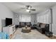 Comfortable living room featuring a ceiling fan, plush seating, and soft, natural light at 223 Tennessee Trl, Lincolnton, NC 28092