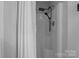 A crisp shower features an adjustable shower head and easy to clean design at 223 Tennessee Trl, Lincolnton, NC 28092
