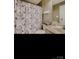 Well-maintained bathroom with tiled shower, white vanity, neutral walls, and decorative shower curtain at 2234 Donnington Nw Ln, Concord, NC 28027