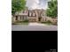 Charming brick home with an attached garage, manicured lawn, and a welcoming entryway at 2234 Donnington Nw Ln, Concord, NC 28027