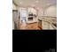 Kitchen featuring stainless steel appliances, wooden floors, and tile backsplash at 2234 Donnington Nw Ln, Concord, NC 28027