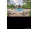Large community pool with lounge chairs and decorative planters in a charming neighborhood setting at 2234 Donnington Nw Ln, Concord, NC 28027