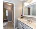 Well-lit bathroom features a vanity with marble countertops and a view of a separate shower at 2325 Perry Rd, Denver, NC 28037