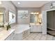 Bright bathroom features a soaking tub, white vanity, and a large window overlooking greenery at 2325 Perry Rd, Denver, NC 28037