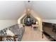 Cozy attic bedroom features a zebra-print sofa and sloped ceilings at 2325 Perry Rd, Denver, NC 28037