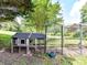Backyard chicken coop with attached pen and watering can nearby at 2325 Perry Rd, Denver, NC 28037