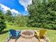 Cozy backyard fire pit with Adirondack chairs on a stone patio at 2325 Perry Rd, Denver, NC 28037