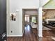 Welcoming foyer with hardwood floors, showcasing the entry to the living spaces and a glimpse of the fireplace at 2325 Perry Rd, Denver, NC 28037
