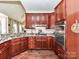 Stylish kitchen with dark wood cabinets, stainless appliances, and ample counter space at 2325 Perry Rd, Denver, NC 28037