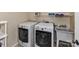 Functional laundry room with modern washer and dryer units, complemented by practical shelving at 2325 Perry Rd, Denver, NC 28037