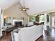 Open-concept living area with a vaulted ceiling, fireplace, and seamless flow into the dining space at 2325 Perry Rd, Denver, NC 28037