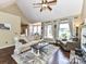 Bright living room with large windows, fireplace, hardwood floors, and neutral décor at 2325 Perry Rd, Denver, NC 28037