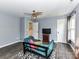 Spacious living room with a fan, a blue futon, and 3 doors at 2325 Perry Rd, Denver, NC 28037