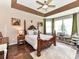 Spacious main bedroom featuring a wooden four-poster bed, tray ceilings, and large windows at 2325 Perry Rd, Denver, NC 28037