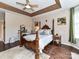 A classic main bedroom featuring a decorative wooden bed frame, dark hardwood floors and neutral paint at 2325 Perry Rd, Denver, NC 28037