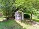 Small storage shed with double doors located in a wooded area at 2325 Perry Rd, Denver, NC 28037