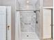 Modern shower features elegant tilework, convenient shelving, and a sleek showerhead at 2325 Perry Rd, Denver, NC 28037