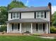 Charming two-story home featuring a welcoming front porch, black shutters, and a well-maintained lawn at 2507 Birnen Dr, Charlotte, NC 28210