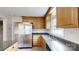 Updated kitchen features stainless steel appliances, wood cabinets, and a view of the sink and window at 2507 Birnen Dr, Charlotte, NC 28210