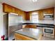 Modern kitchen with stainless steel appliances, wooden cabinets, and a center island at 2507 Birnen Dr, Charlotte, NC 28210