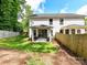 View of the home's backyard with a well-kept lawn, patio, and wooden fence providing privacy at 2517 Marlowe Ave, Charlotte, NC 28208